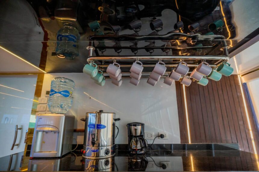 A formally set dining table aboard the Hammerhead II with wine glasses and folded napkins