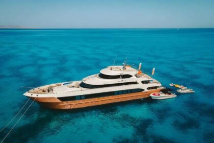 Hammerhead II liveaboard yacht anchored in turquoise water with two tender boats alongside