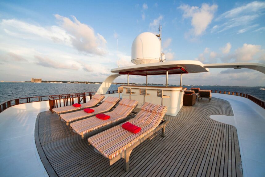 Sun loungers on MV Theia's sundeck at sunset with the radar dome behind