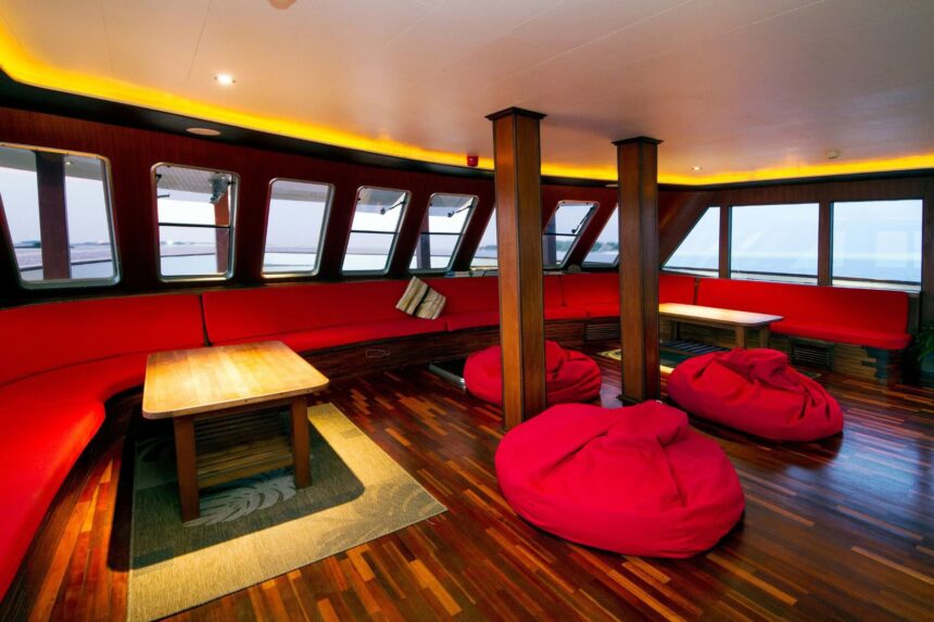 Red sofa seating and beanbags in MV Theia's saloon lounge
