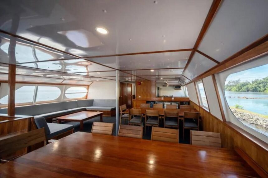 Indoor dining lounge aboard MV Oceania with wraparound windows