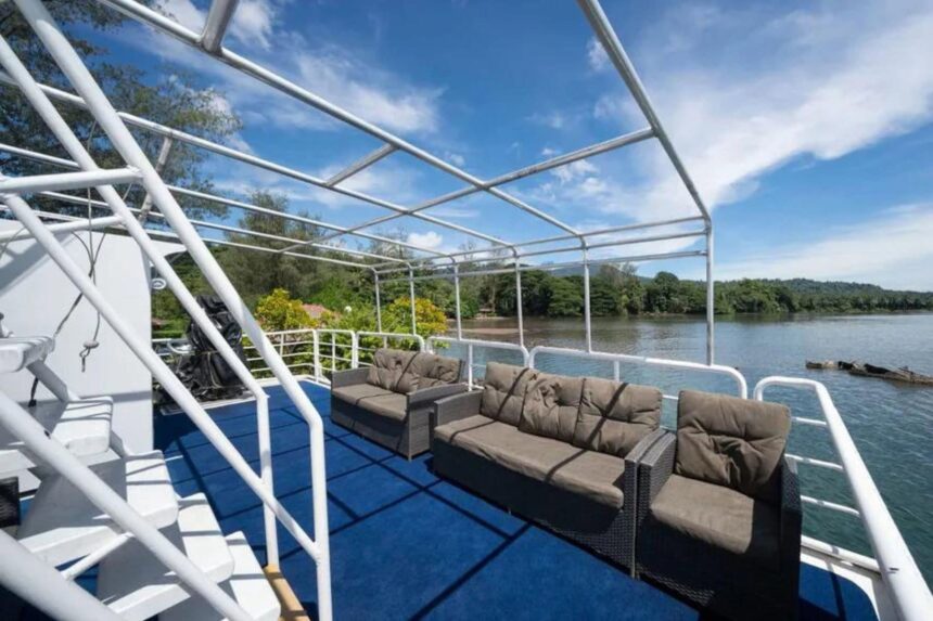 Shaded lounge seating on MV Oceania's upper deck overlooking the coastline
