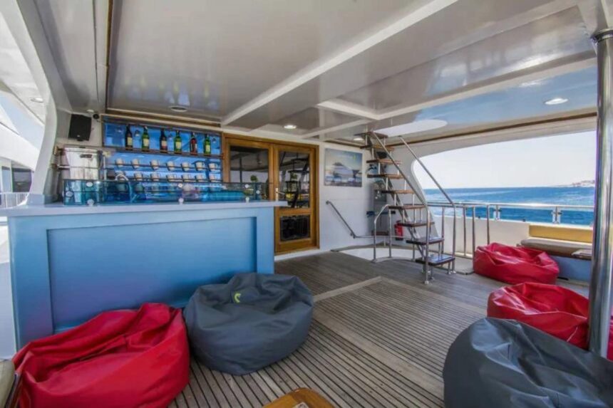 Blue bar counter with red and gray beanbag seating on the Sea Serpent Contessa's deck