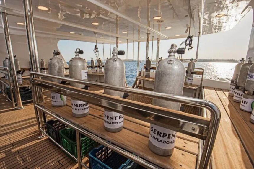 Scuba tanks racked on the dive deck, labeled for the Sea Serpent fleet