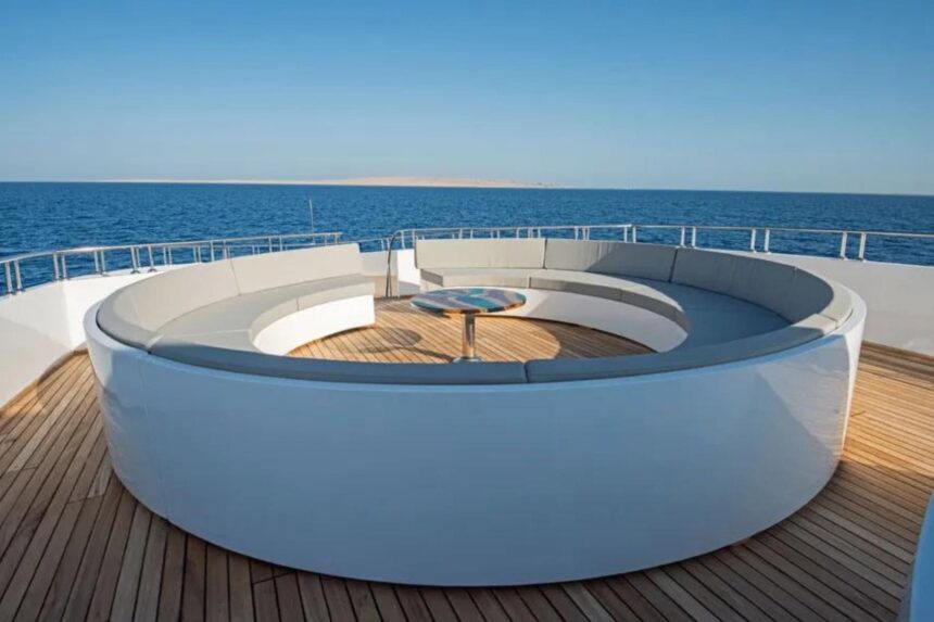 Stern deck with a round white sofa and views of the ship's bridge on the Sea Serpent Excellence