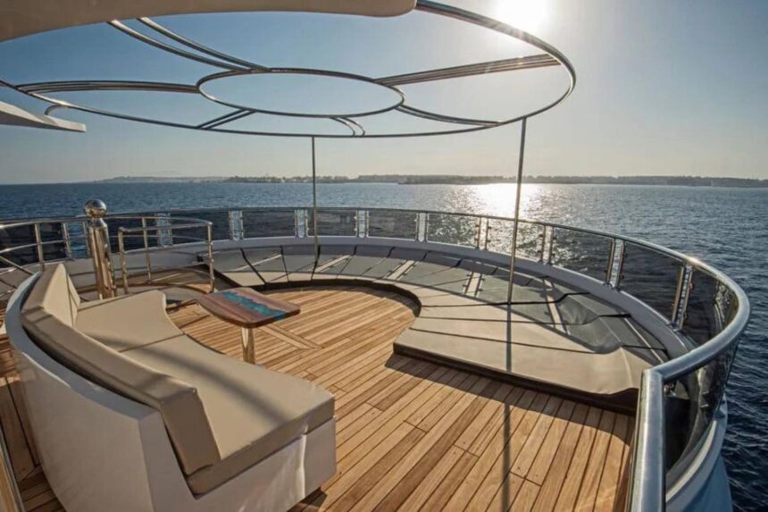 Circular white lounge seating on the open deck of the Sea Serpent Excellence