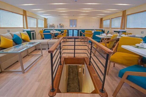 Dining room with a green cabinet and yellow and teal chairs on the Sea Serpent Excellence