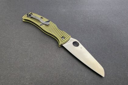Spyderco Caribbean folding knife open, showing its sheepfoot blade and yellow and black striped handle