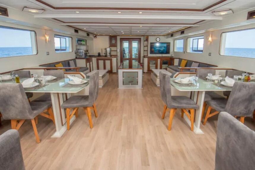 dining salon with tables and lounge seating aboard the Sea Serpent