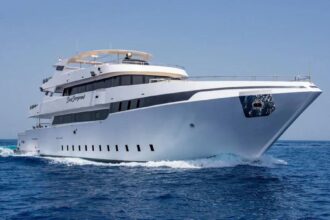 The Sea Serpent liveaboard yacht underway with spray at the bow