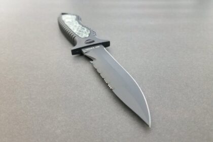 XS Scuba Neuro dive knife with black coated part-serrated blade and moulded grey and black handle