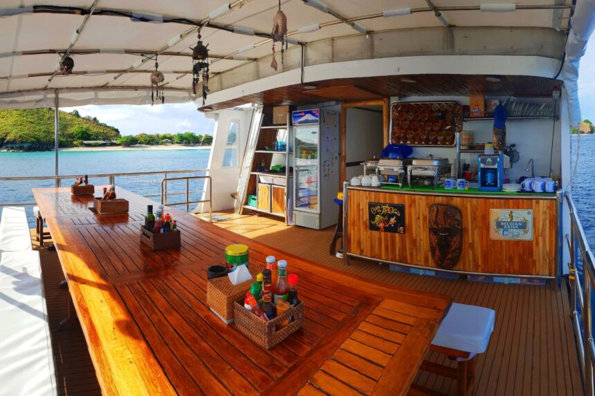 wooden dining table set with condiments on the open deck aboard the Seadoors