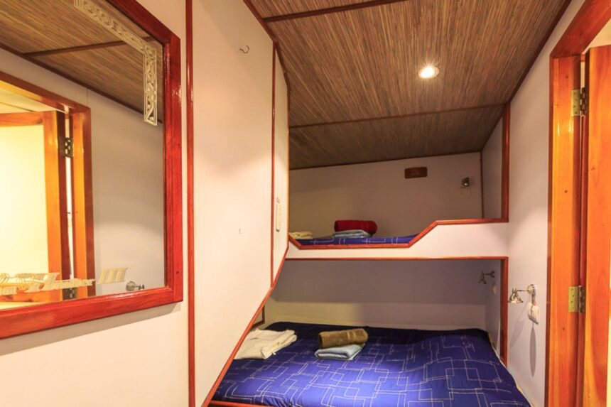 cabin with bunk beds and red trim aboard the MV Ocean Hunter III