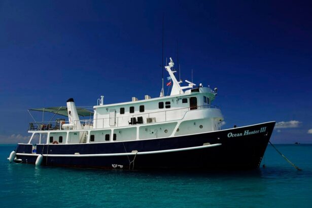The Ocean Hunter III liveaboard anchored in deep blue water under a clear sky