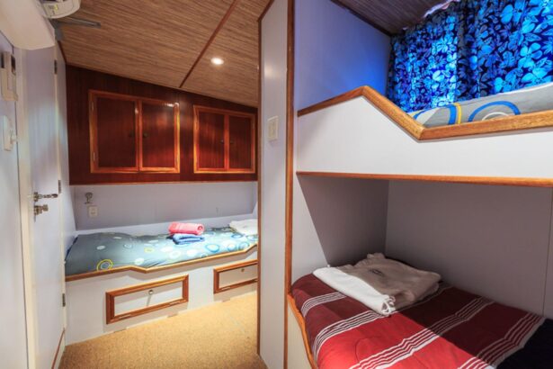 Twin bunk cabin with striped bedding aboard the Ocean Hunter III