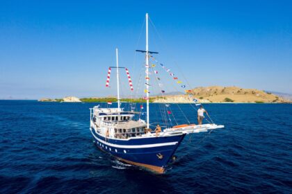 The MSY Seahorse liveaboard sailing yacht near a tropical island with signal flags flying