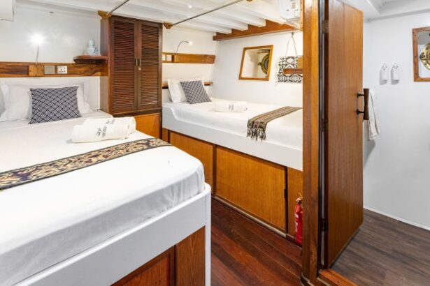 Twin-bed cabin with wooden cabinetry and a decorative dreamcatcher on the wall