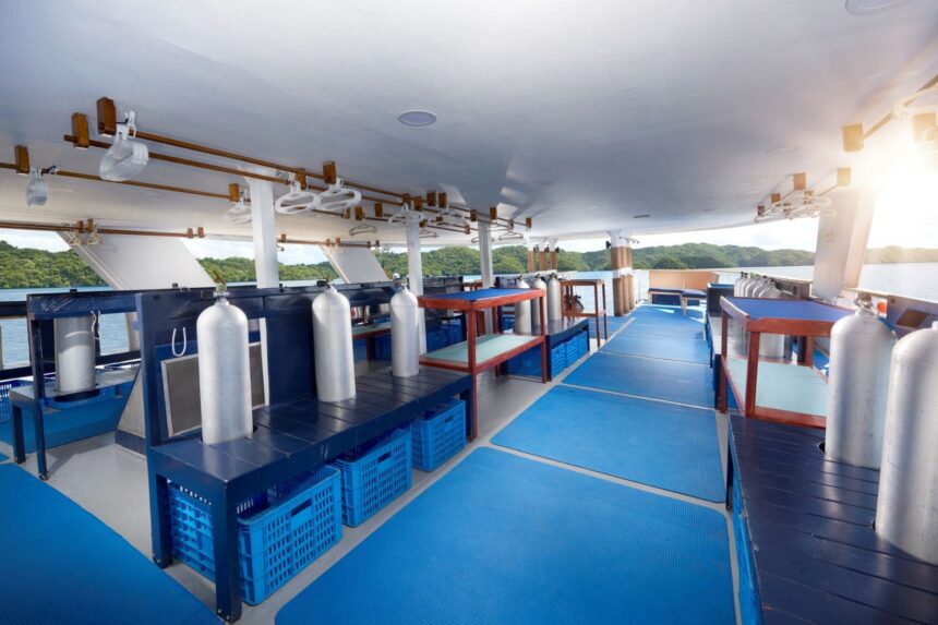 Dive deck loaded with tanks and gear racks ready for the next dive