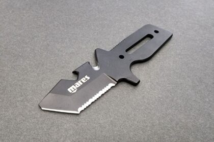 Mares Neutron dive knife, a one piece black steel design with blunt nose, serrations and line cutter notch