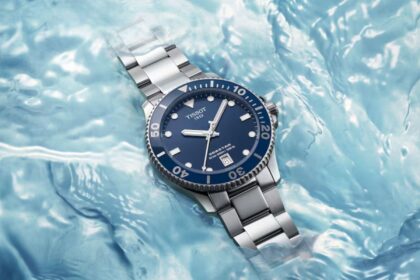 Tissot Seastar 1000 Powermatic with blue dial and steel bracelet resting in rippling water