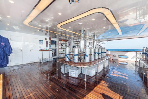 Scuba tanks lined up on the nitrox fill station aboard the Alia liveaboard