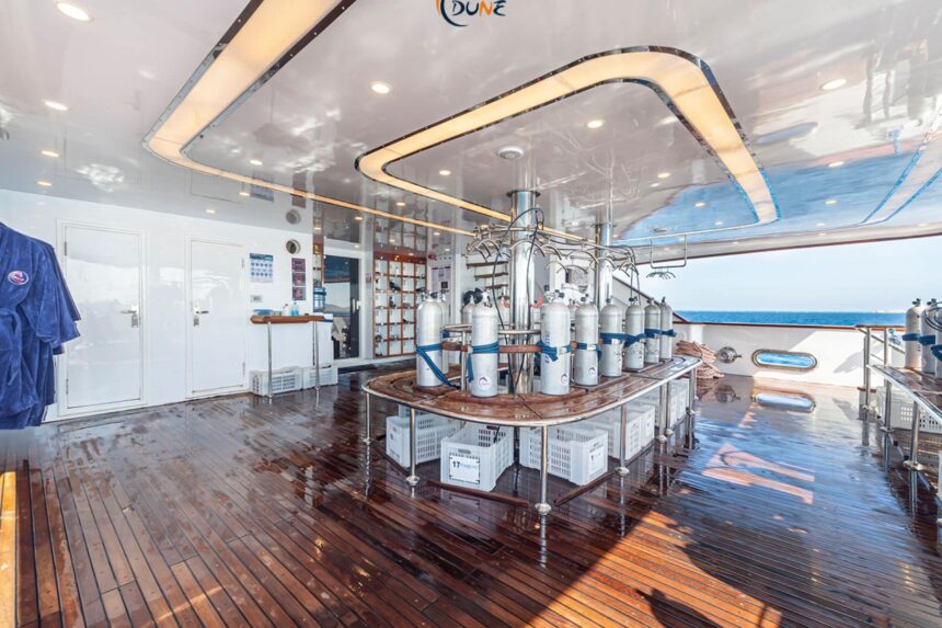 Scuba tanks lined up on the nitrox fill station aboard the Alia liveaboard