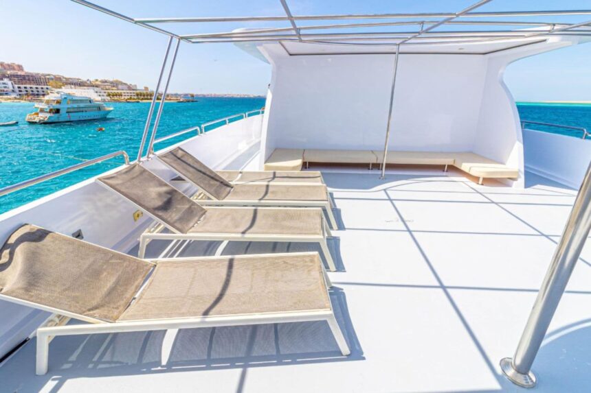 Row of sun loungers on the Betelgueser's sundeck overlooking the harbor