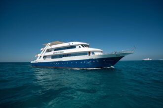 the liveaboard Betelgeuser cruising on blue water under a clear sky