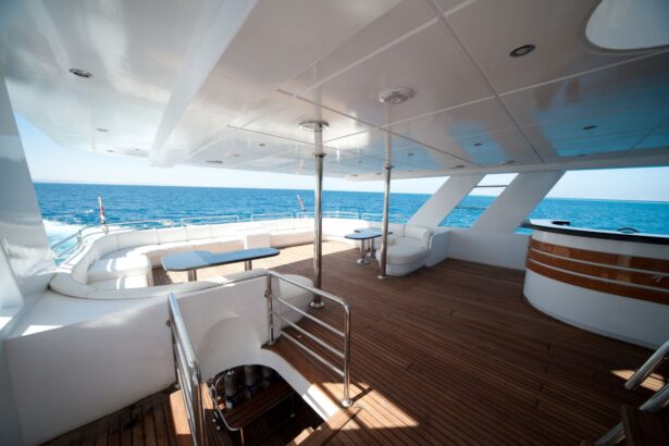 White cushioned lounge seating on the Betelgueser's upper deck overlooking the sea