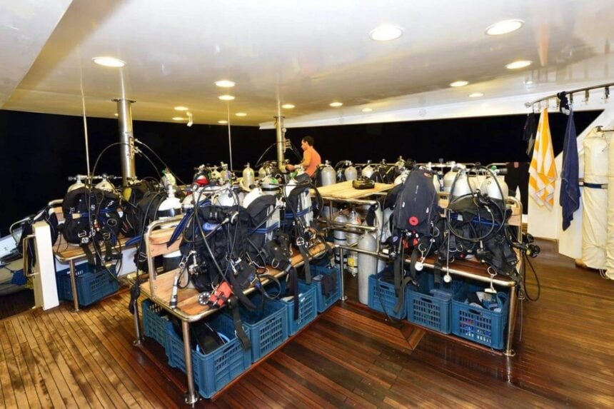 Scuba gear and tanks stored on equipment racks aboard the MY Blue