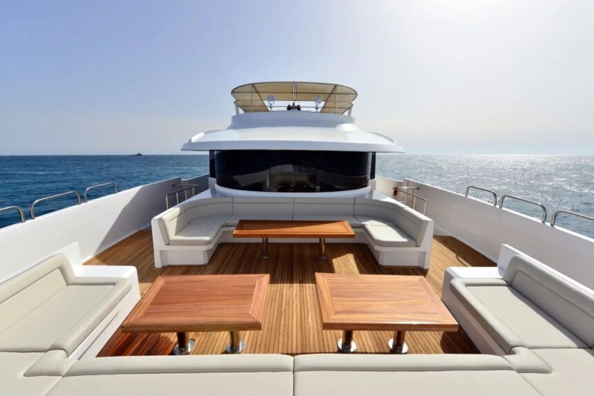 Bow lounge seating and wooden tables on the MY Blue's sundeck