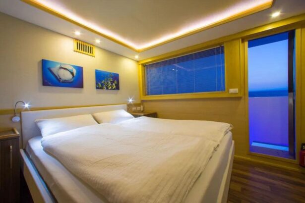 Cabin bed aboard the MY Blue lit with ambient blue lighting at night