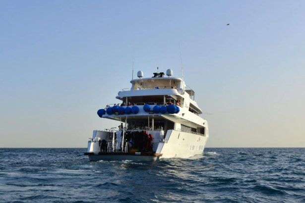 Stern view of the MY Blue liveaboard with divers preparing gear on deck