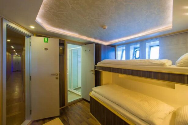Bunk bed cabin aboard the MY Blue with open doors to the corridor and bathroom