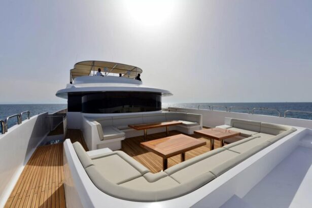 Bow lounge seating on the MY Blue with the captain visible on the upper deck