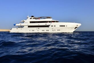 the liveaboard MY Blue cruising along a desert coastline