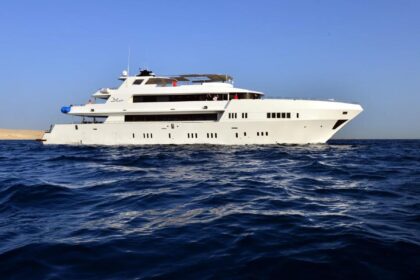 the liveaboard MY Blue cruising along a desert coastline