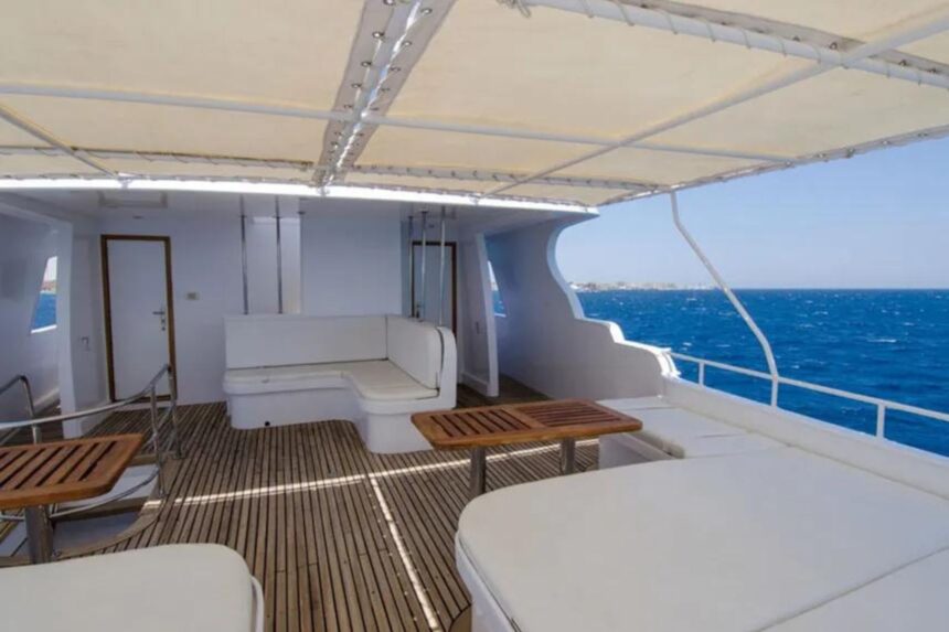 Shaded bow lounge seating with wooden tables on the MY Blue Planet 1