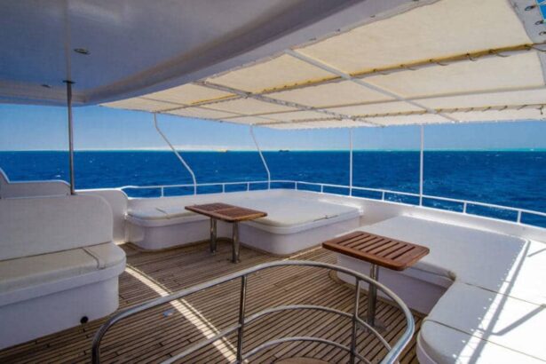 Shaded outdoor lounge deck with wooden tables on the MY Blue Planet 1