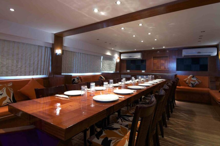 Long dining table set for guests aboard the MY Blue Planet 1 liveaboard