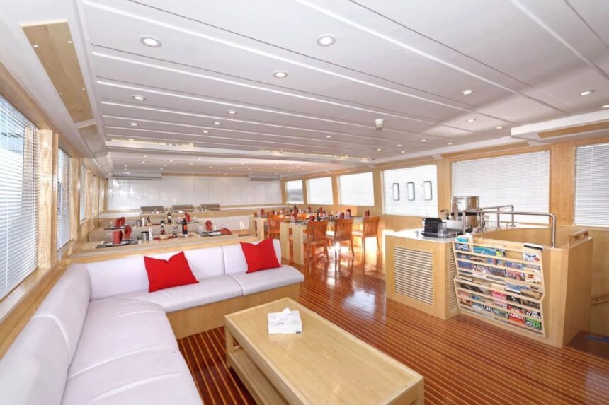 Indoor lounge and dining area with sofas and bar aboard the MY Blue Pearl