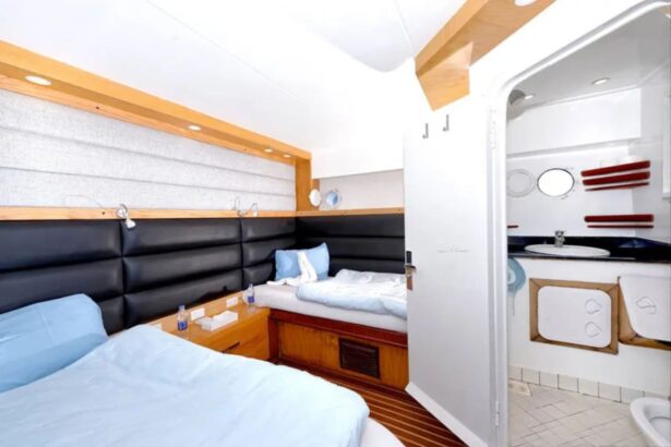 Cabin bunk bed with white and red bedding aboard the MY Blue Pearl