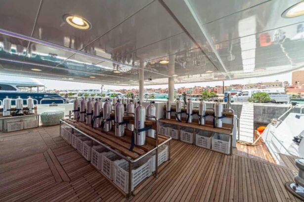Scuba tanks racked on deck near the stairs on the MY Blue Storm