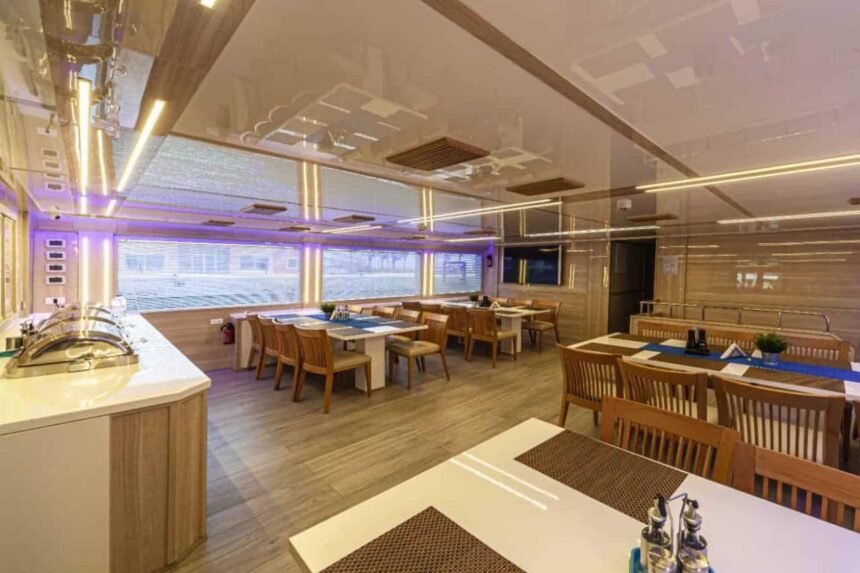 Indoor restaurant with wooden dining tables aboard the MY Blue Storm