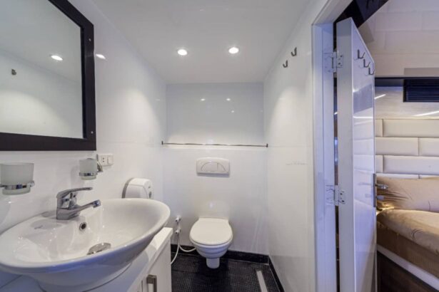 En suite bathroom aboard MY Blue Storm with sink, toilet and view into the adjoining cabin