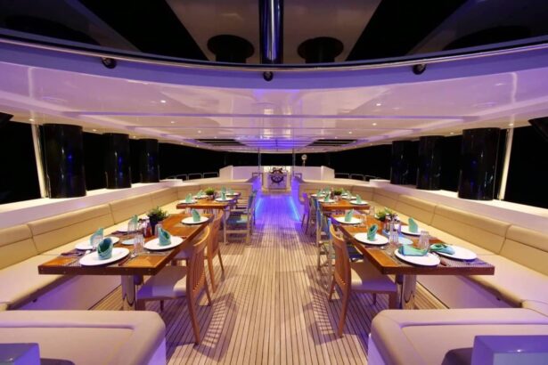 Dining salon lit in purple at night aboard the MY Blue Storm