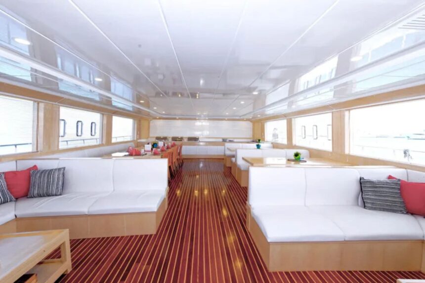 Bright indoor lounge with white sofas and a wood-striped floor aboard the MY Blue Seas