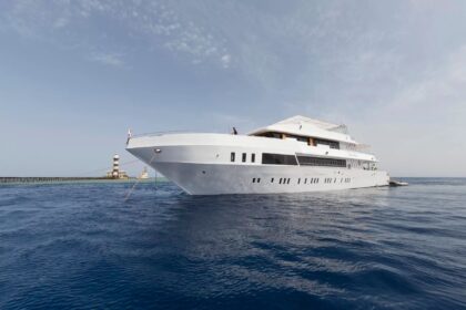 the MY Blue Seas liveaboard anchored near a lighthouse