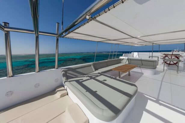 Shaded lounge seating on the MY Blue Seas deck overlooking turquoise reef waters