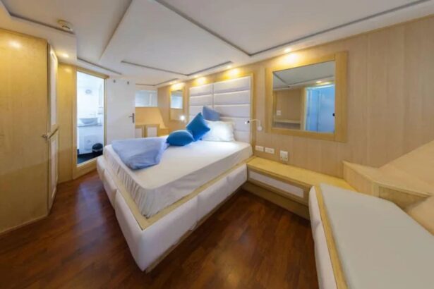 Double cabin aboard the MY Blue Seas with wood paneling and blue throw pillows